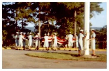 Women's Army Corp (WAC) unfolding U.S. flag