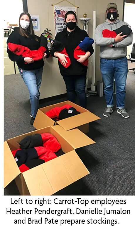 Carrot-Top employees prepare stockings for Soldiers' Angels