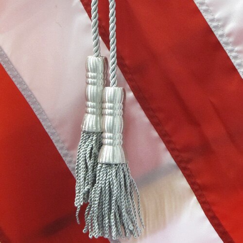 flag tassels on red background