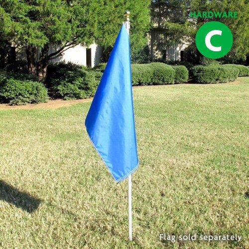 blue flag on white pole in grass