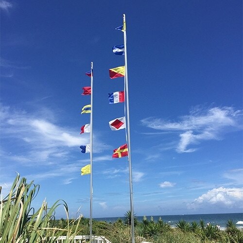 colorful flags on beach poles