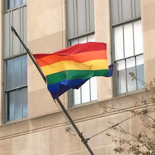 rainbow flag flying outside buildin